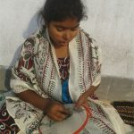 A young girl doing emroidery